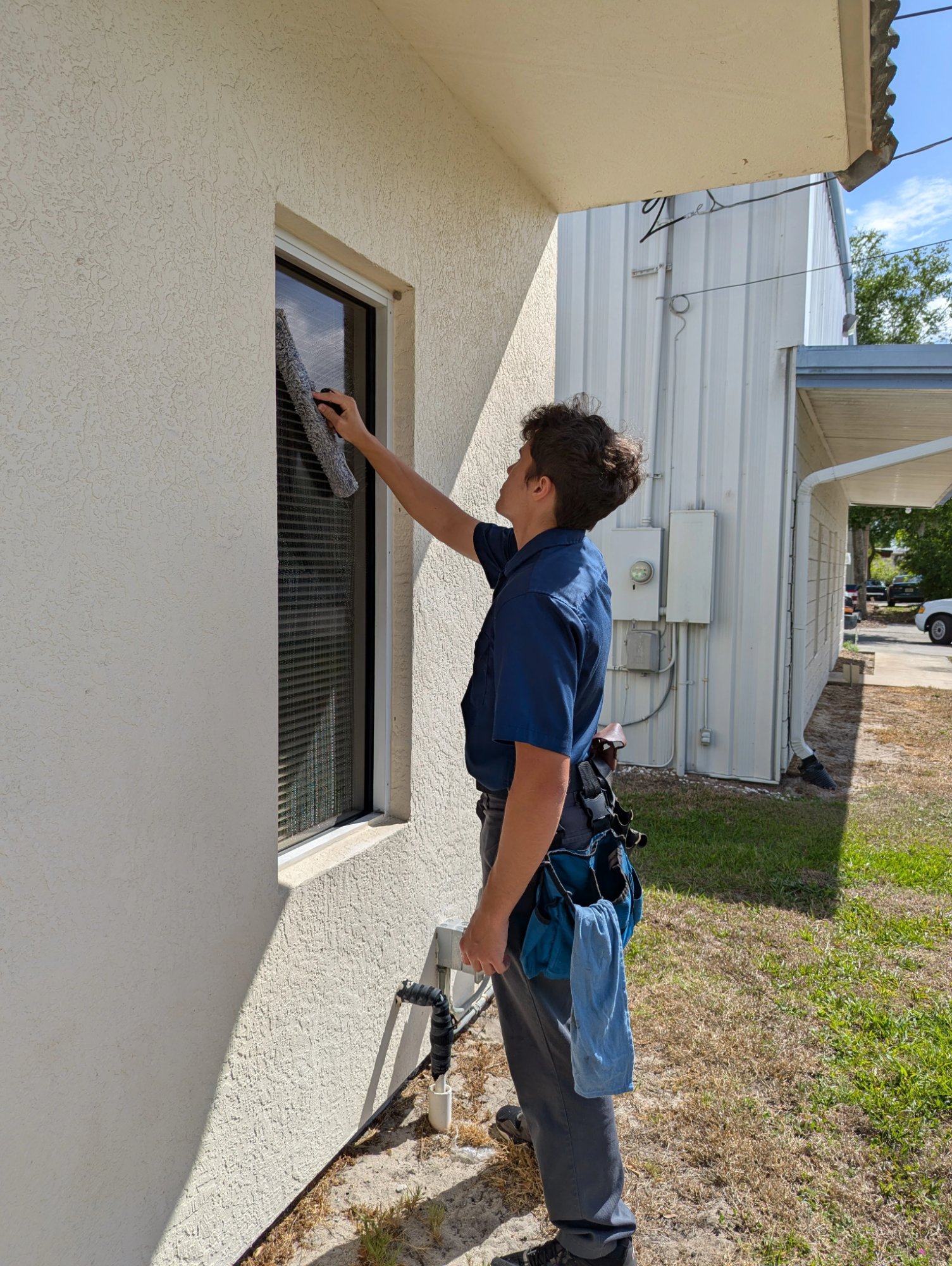 Ian Reed cleaning residential window
